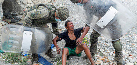 Ein marokkanischer Junge wird nach dem Grenzübertritt von spanis... Ein marokkanischer Junge wird nach dem Grenzübertritt von spanis...